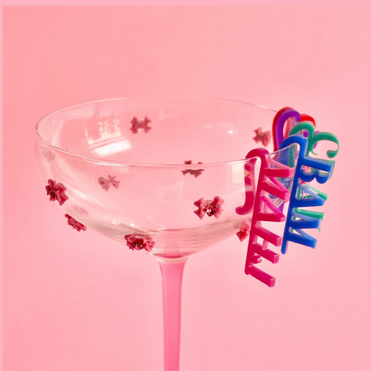 Mahjong drink tag on a pink champagne glass
