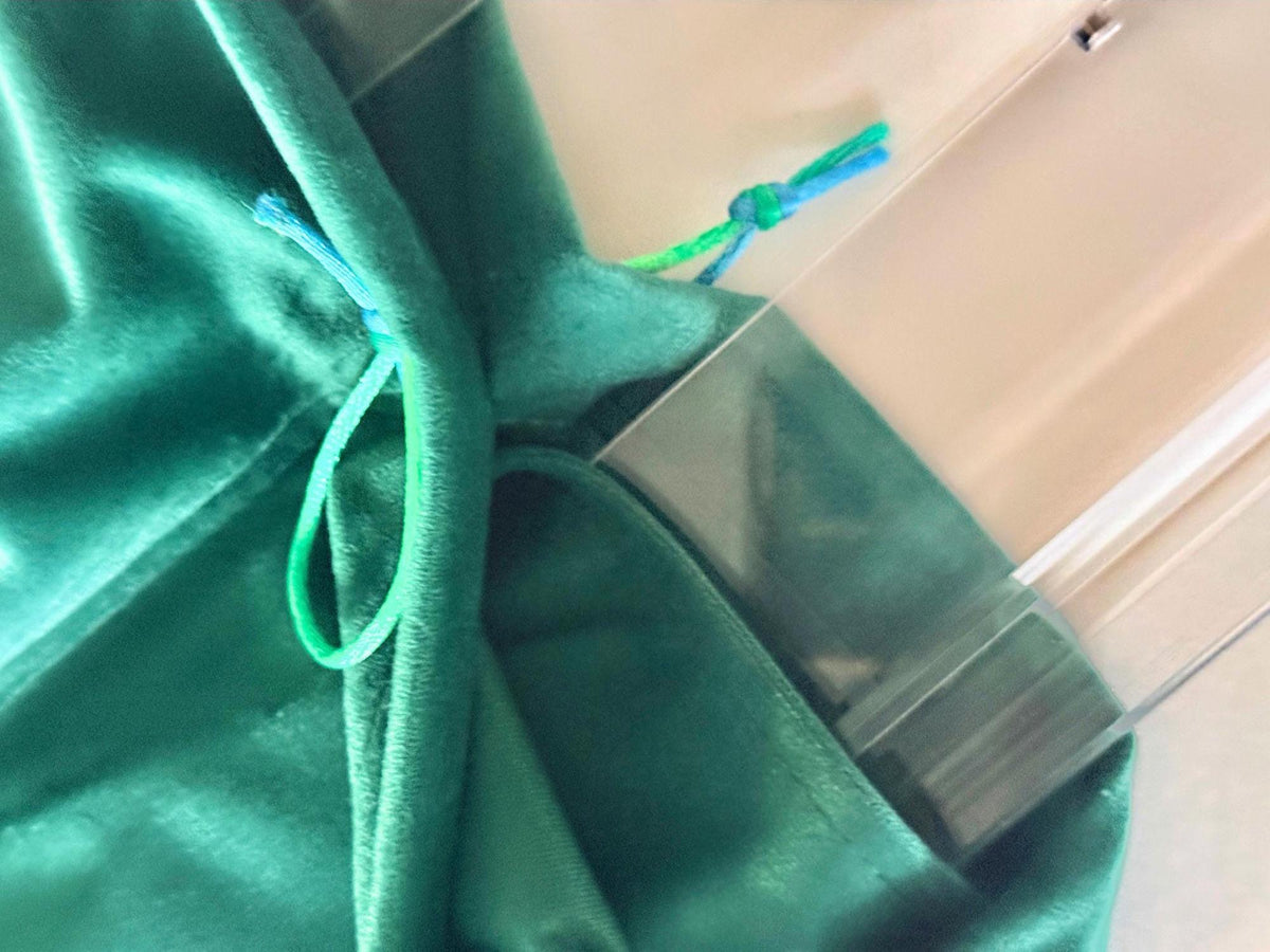 Emerald green velvet rack bag drawstring detail