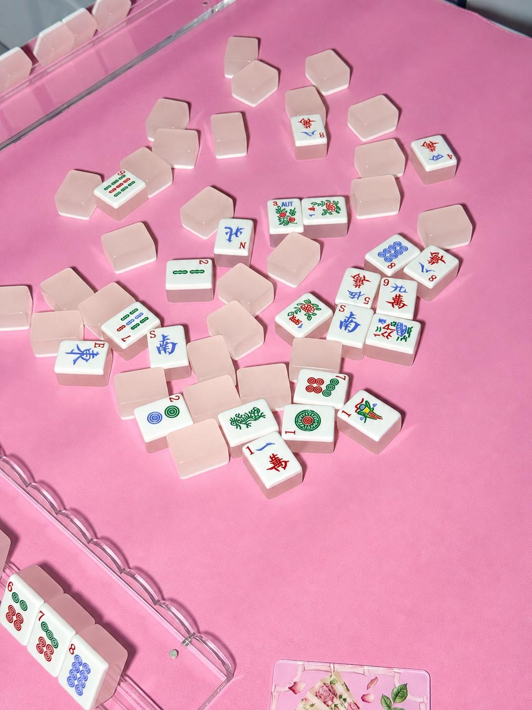 Mahjong tiles on a pink vegan leather Mahjong mat
