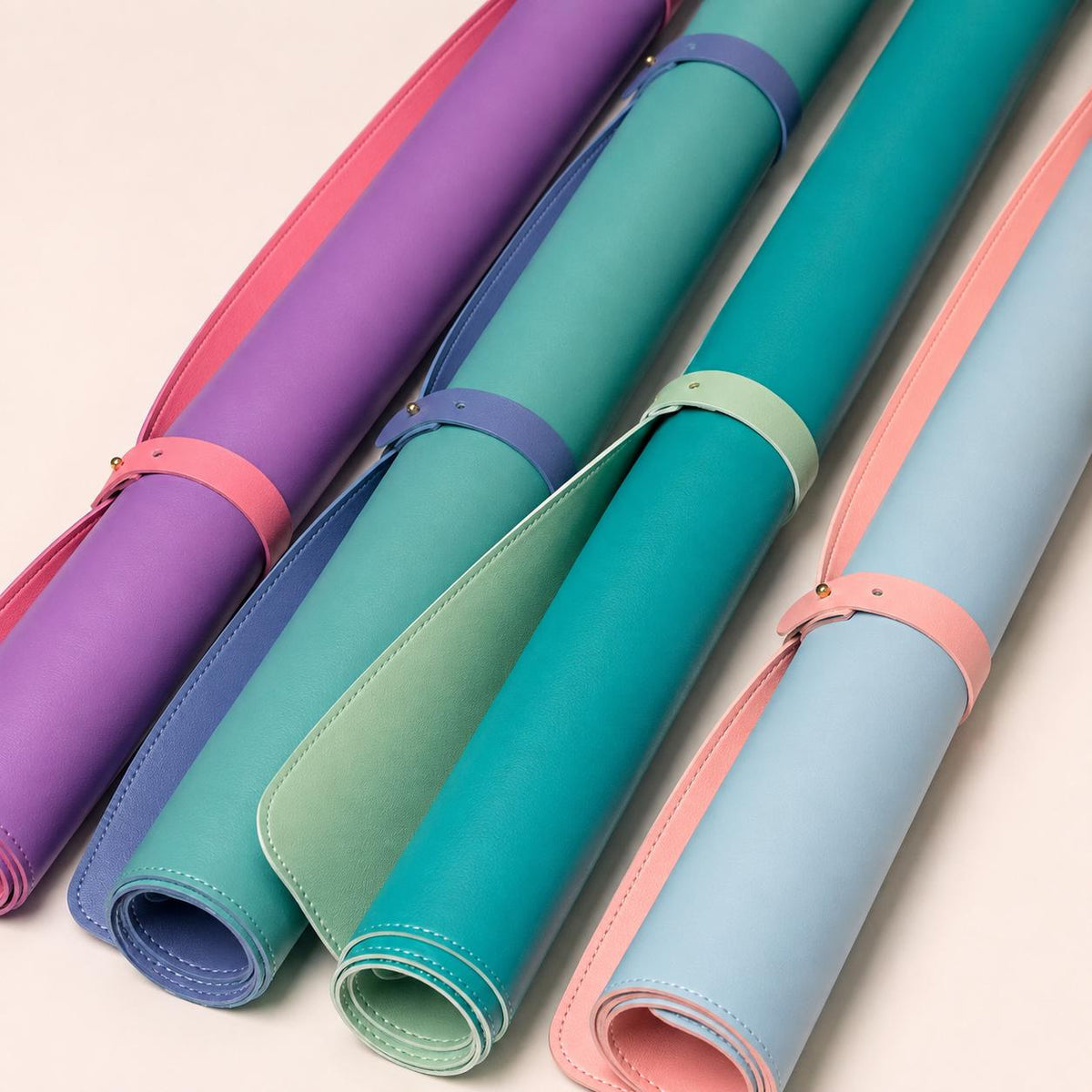 Four rolled reversible Mahjong mats with contrasting straps
